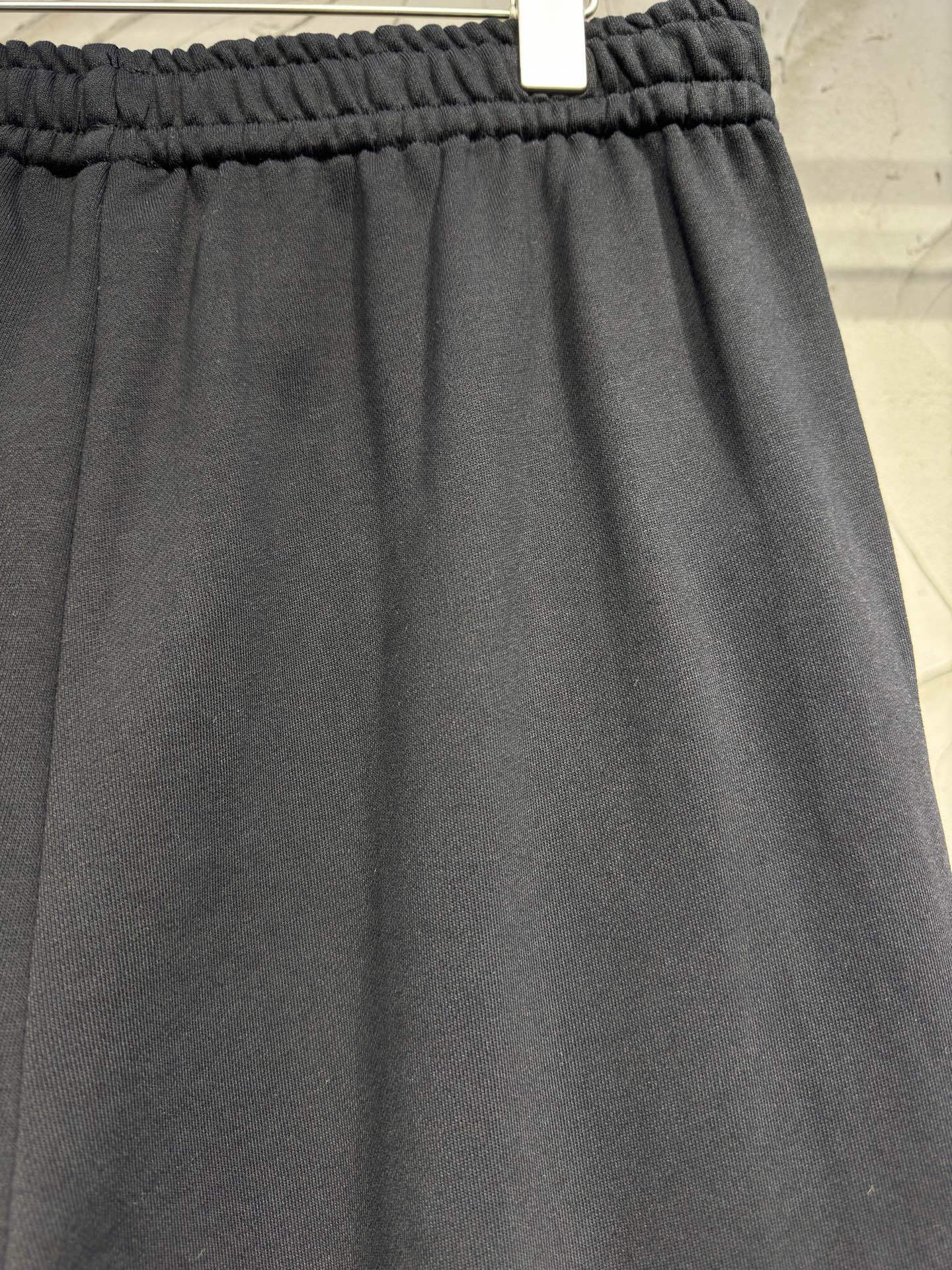 Dark pants with elastic waistband and relaxed straight leg opening