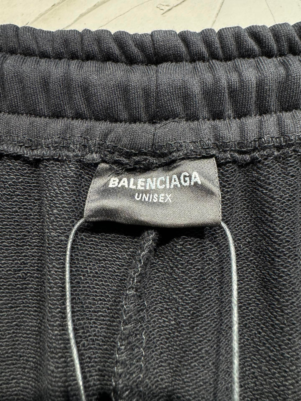 Black pants with BALENCIAGA UNISEX label at elastic waistband