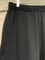 Black wide-leg pants with elastic waistband and smooth draped front