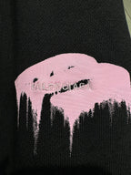 Dark knit pants with pink mountain logo graphic detail