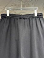 Black wide-leg pants with elastic waistband and relaxed straight legs