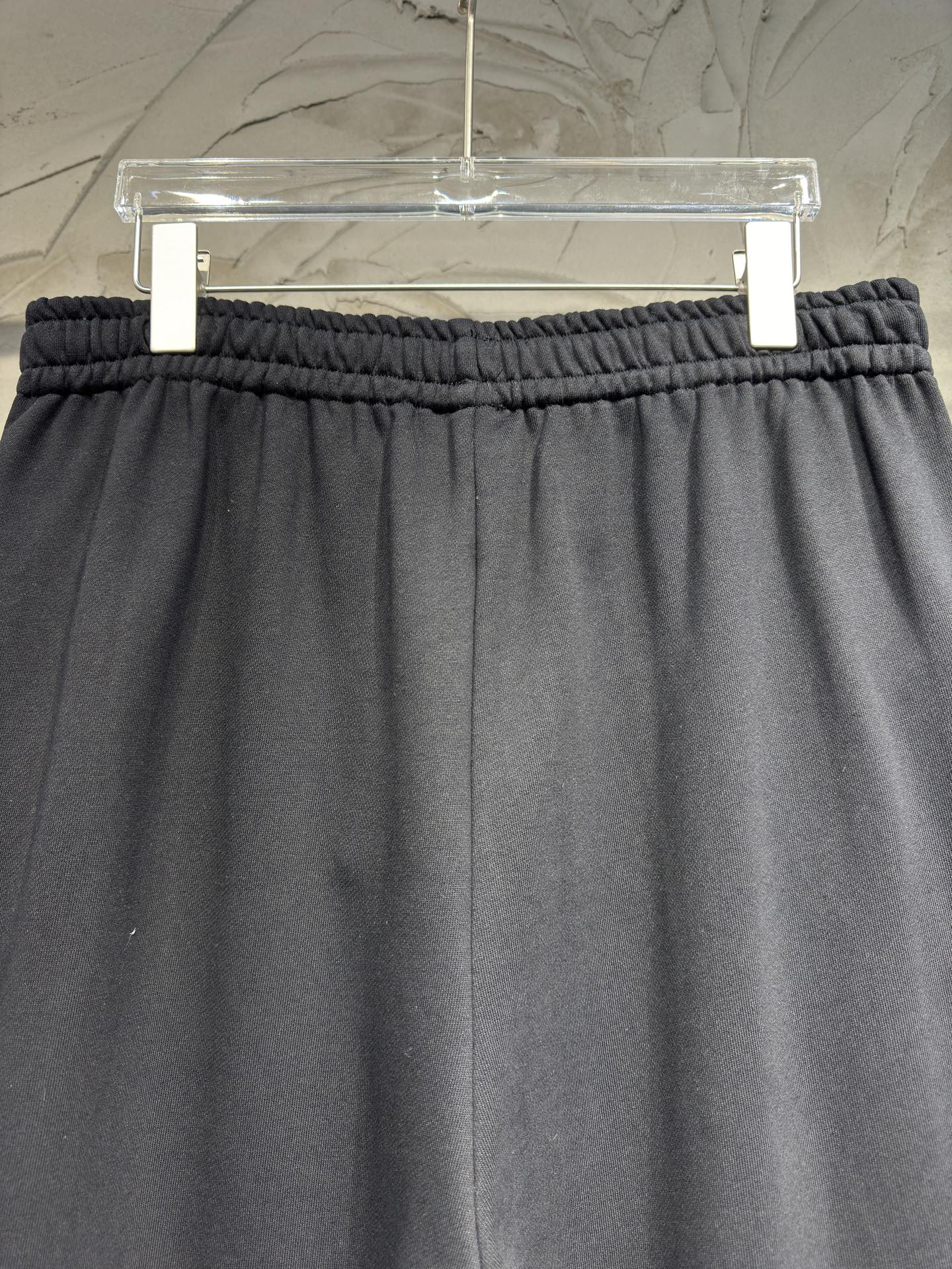 Black wide-leg pants with elastic waistband and relaxed straight legs