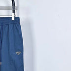 Prada pants in dark blue with elastic waist and triangular logo patch on leg