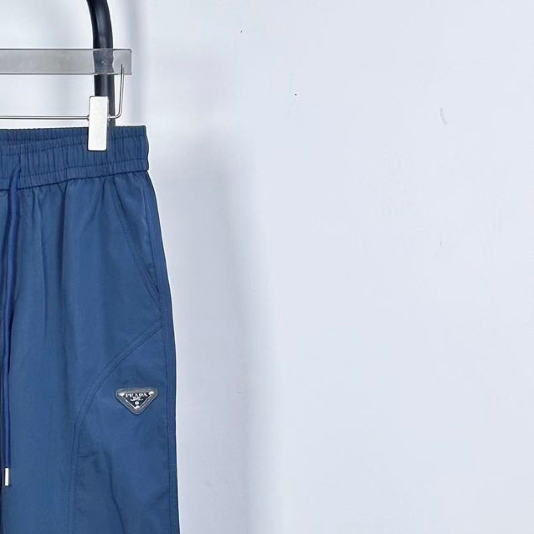 Prada pants in dark blue with elastic waist and triangular logo patch on leg