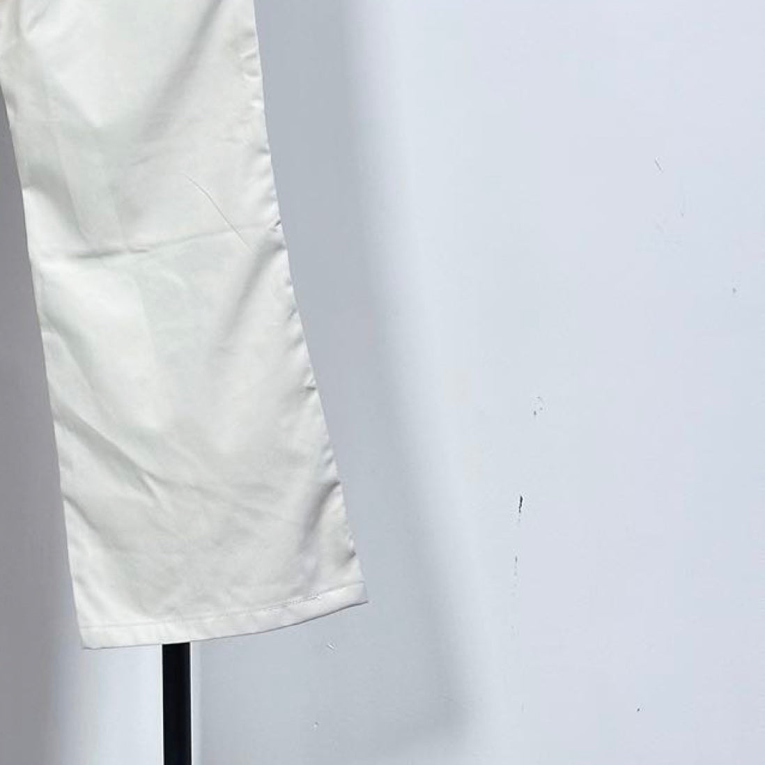 White pants leg with cuffed hem