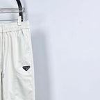 Prada white pants with triangle logo patch, elastic waist and drawstring