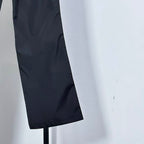 Prada dark pants leg with slight crease and cropped hem