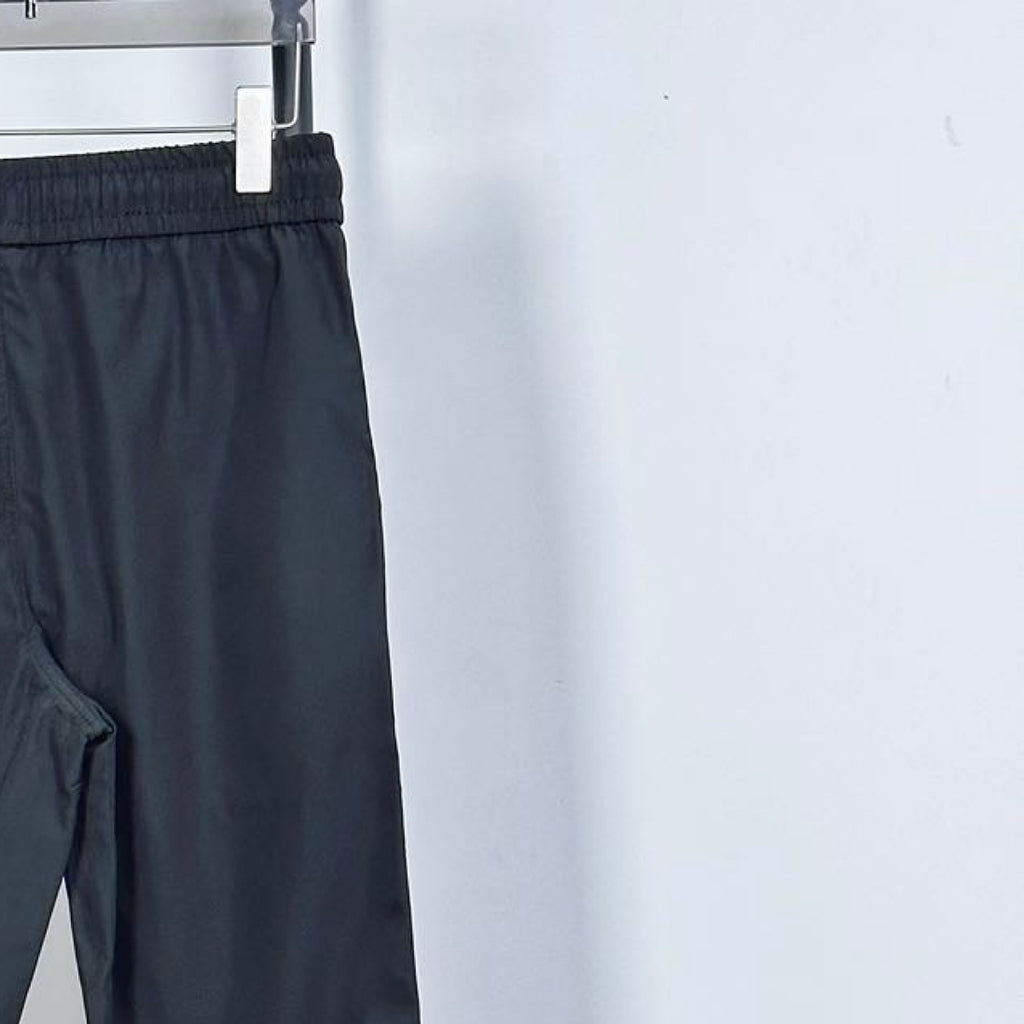 Prada pants in dark navy with elastic waistband and drawstring; side seam view