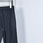 Prada pants in dark navy with elastic waistband and drawstring; side seam view