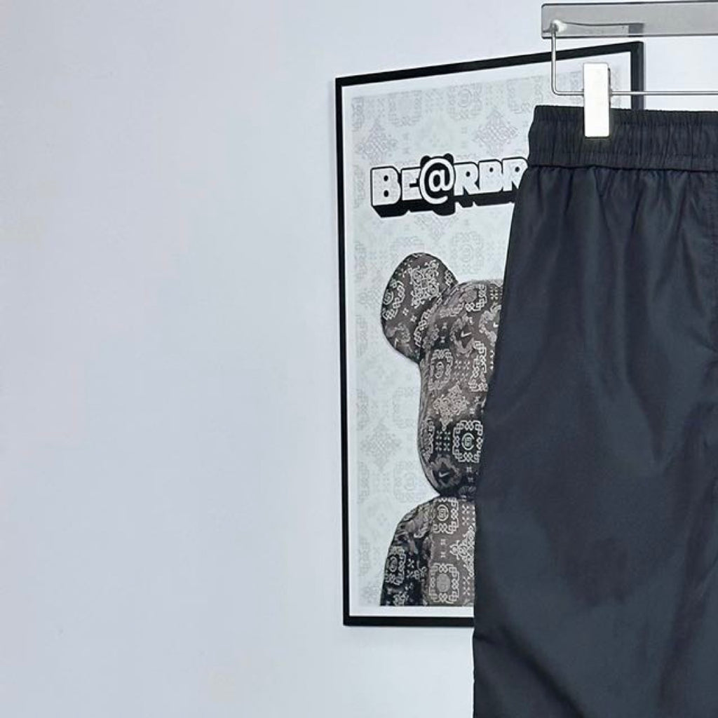 Prada pants in dark navy with elastic waistband and drawstring; leg pocket seams