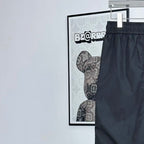 Prada pants in dark navy with elastic waistband and drawstring; leg pocket seams