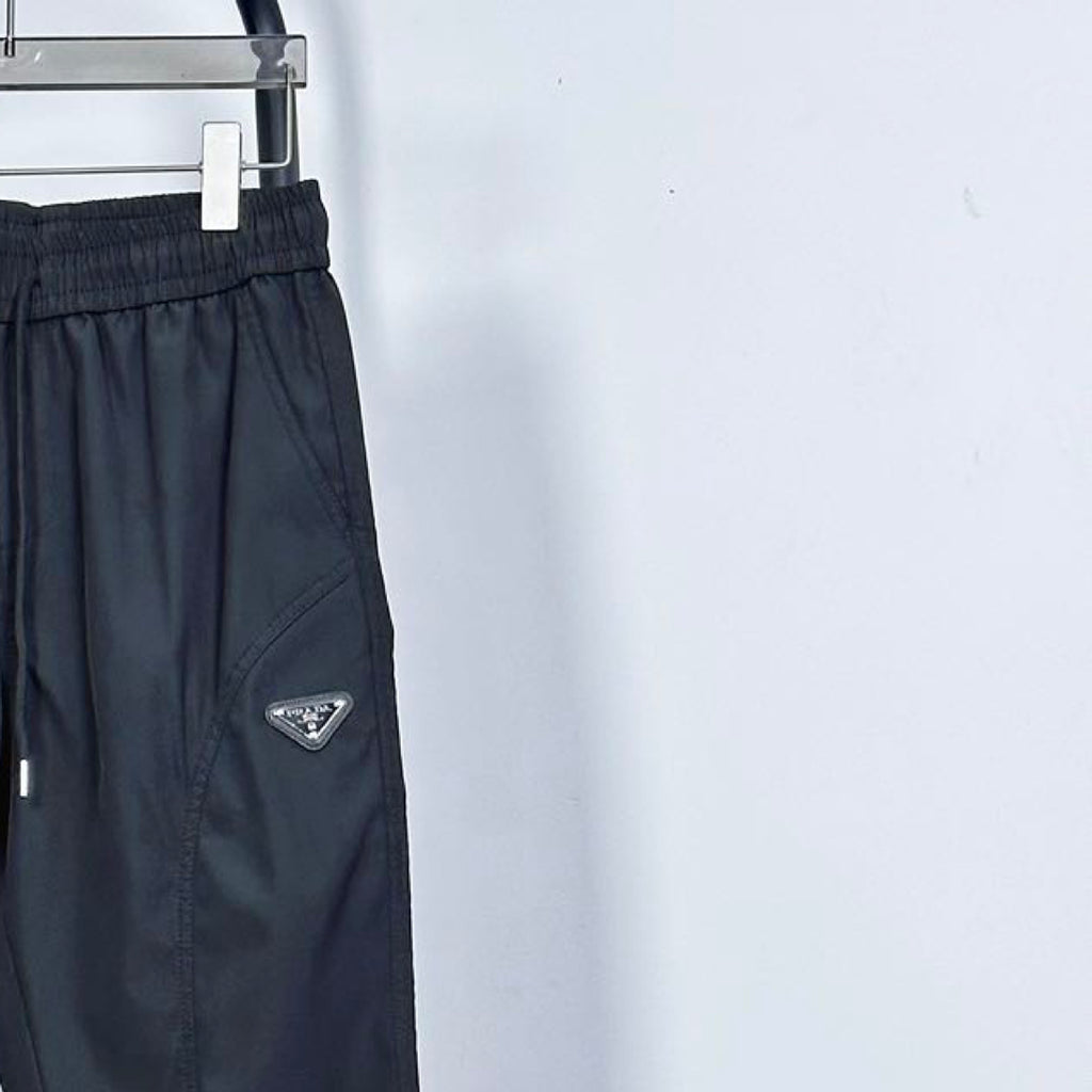 Prada pants in dark navy with side logo patch and drawstring at elastic waist