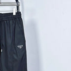Prada pants in dark navy with side logo patch and drawstring at elastic waist