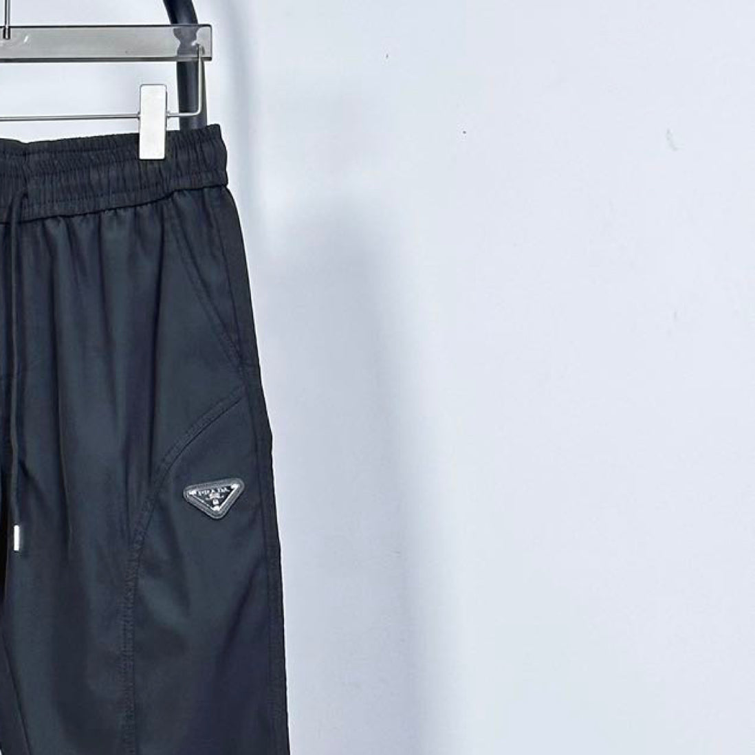 Prada pants in dark navy with side logo patch and drawstring at elastic waist