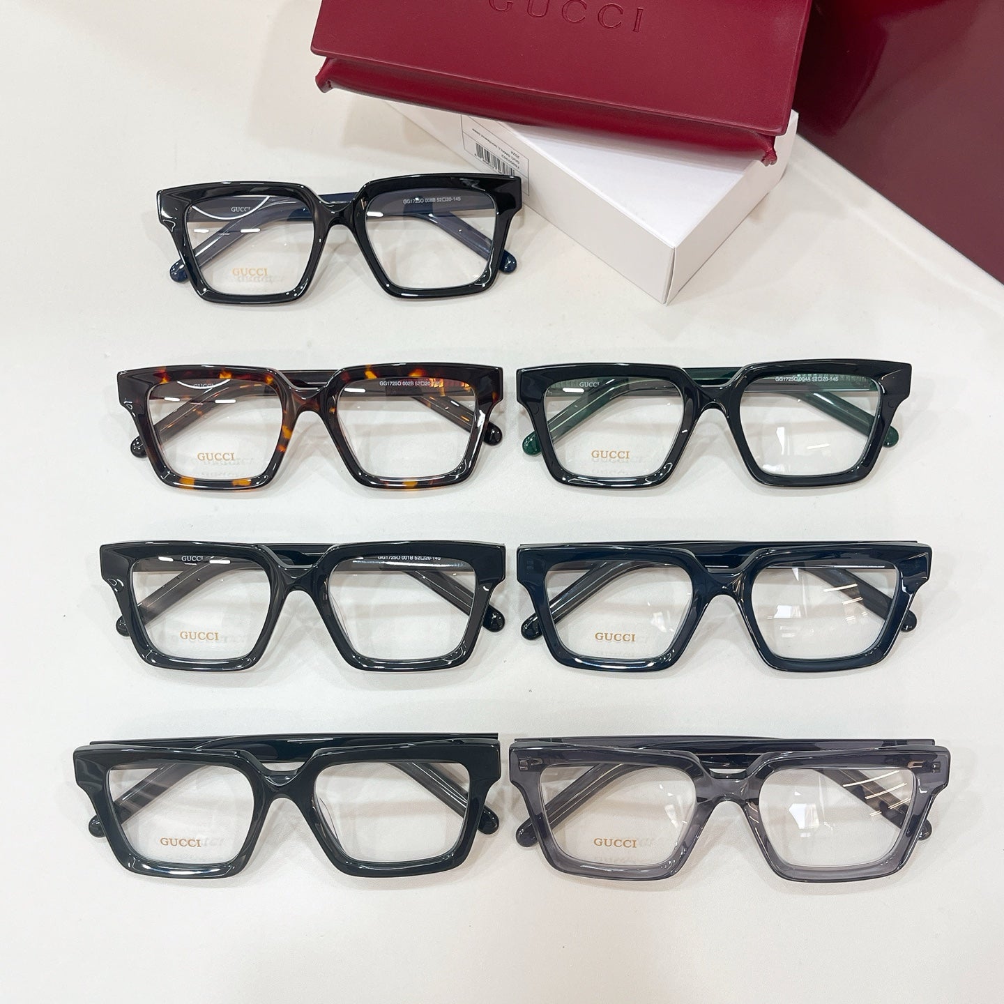 Assorted rectangular eyeglasses with clear lenses and mixed frame colors in one view
