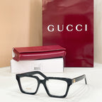 Rectangular eyeglasses with dark frame and clear lenses, subtle gold-tone temple detail