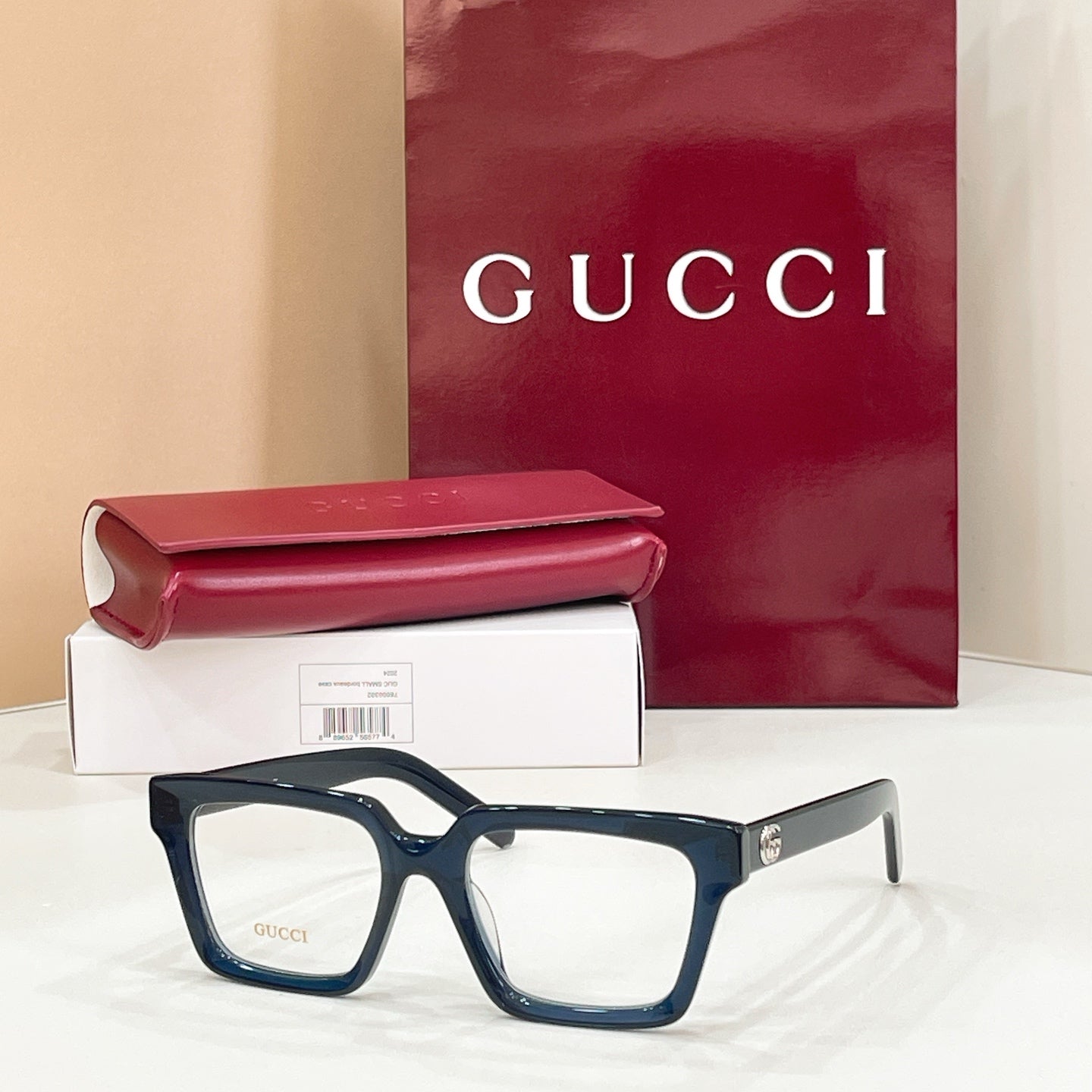 Rectangular eyeglasses with dark blue frame and light lenses, metal temple detail