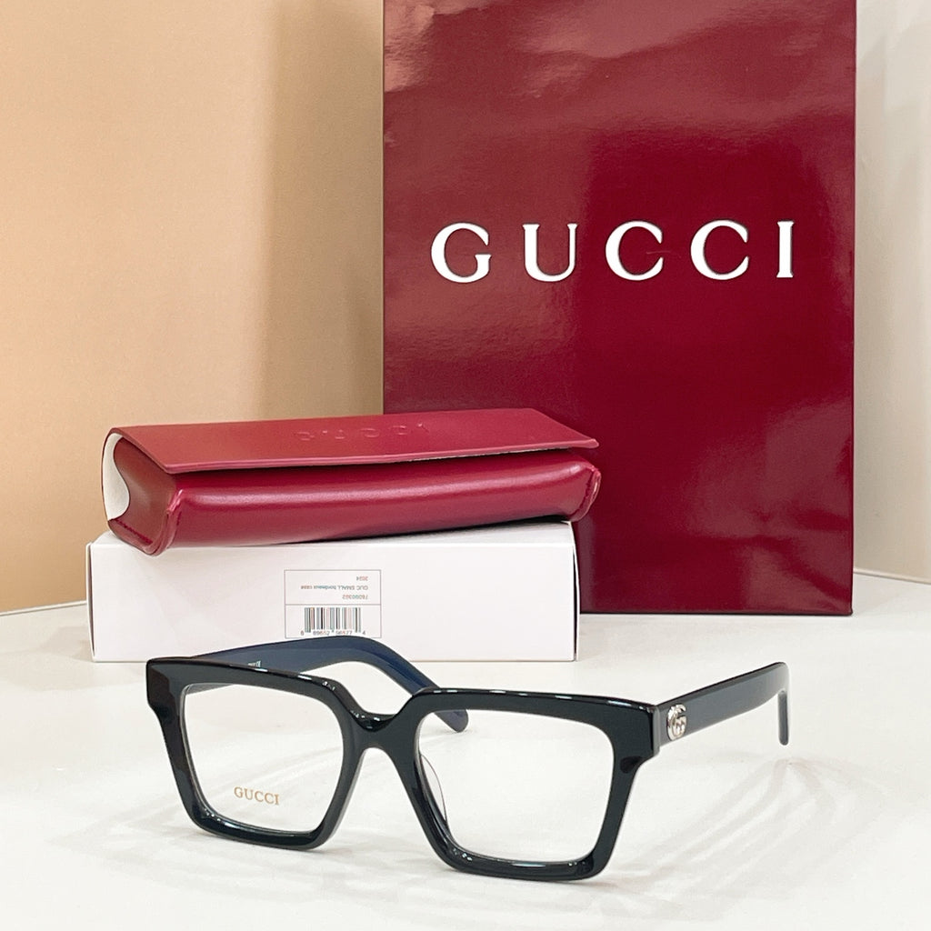 Rectangular eyeglasses with dark blue frame and clear lenses, gold-tone temple emblem
