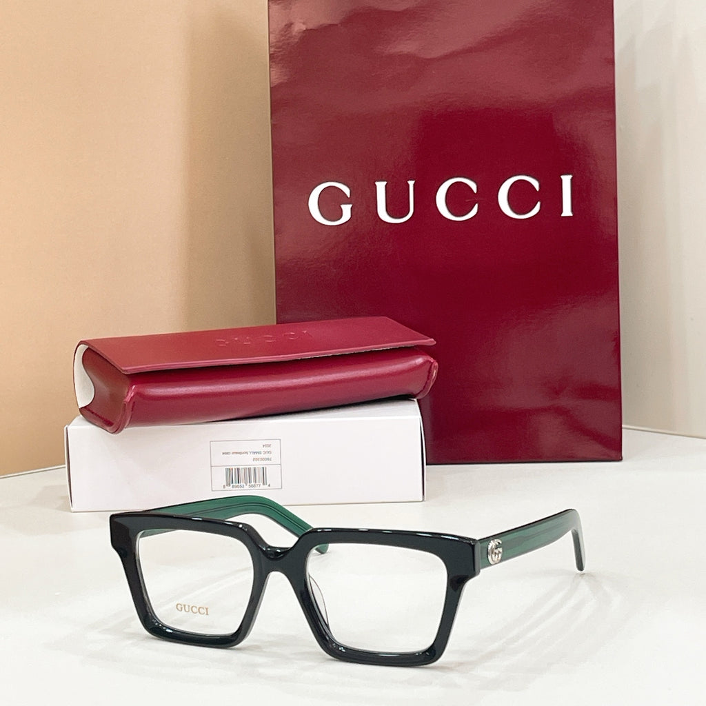 Rectangular eyeglasses with dark frame and light lenses, with green-accent temple tips