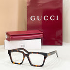 Rectangular eyeglasses with dark frame and clear lenses, tortoiseshell temple pattern