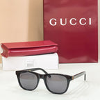 Gucci sunglasses with black frame and gray tinted lenses