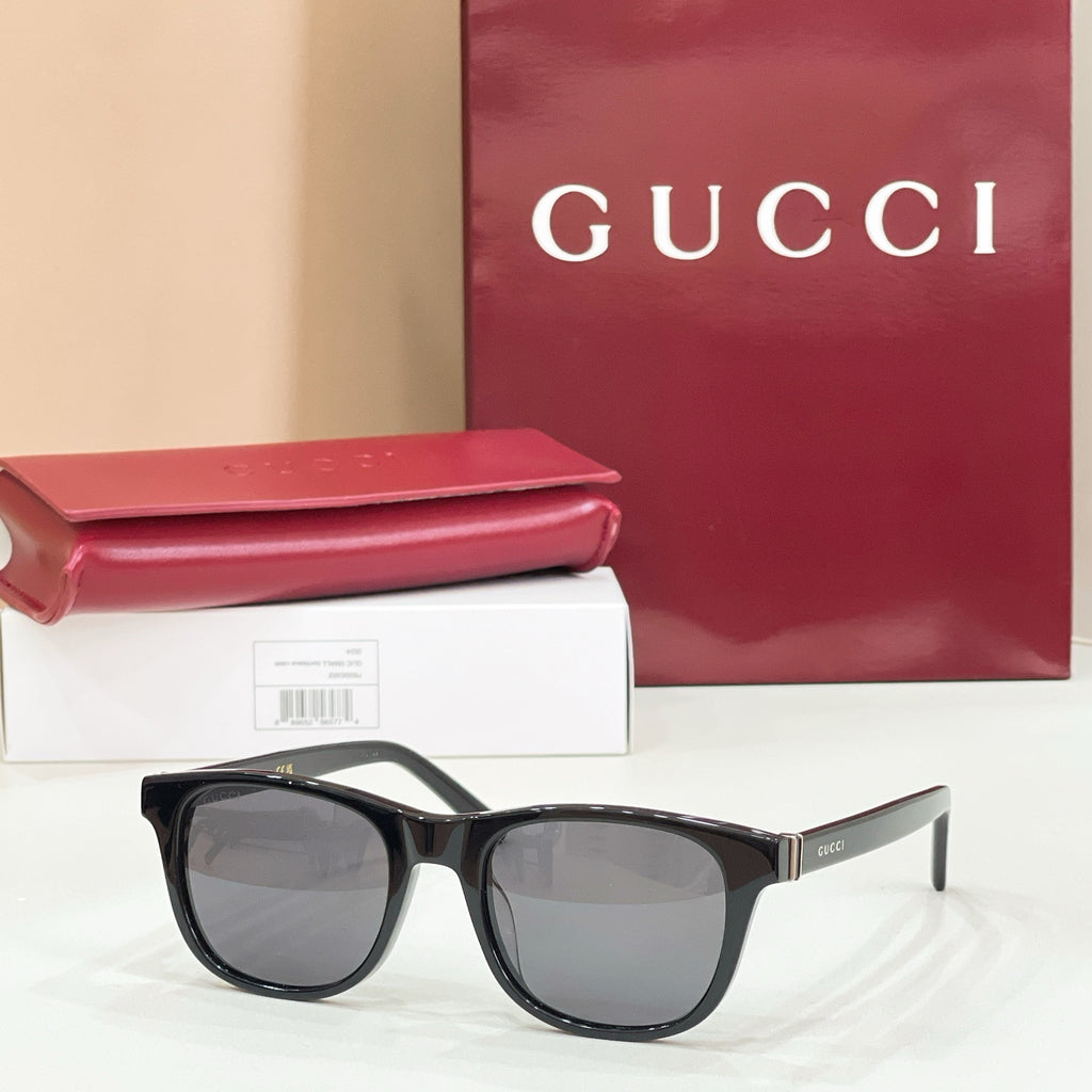 Gucci sunglasses with black frame and gray tinted lenses