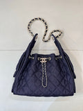 Chanel quilted dark blue bucket bag with chain handles and gold logo front