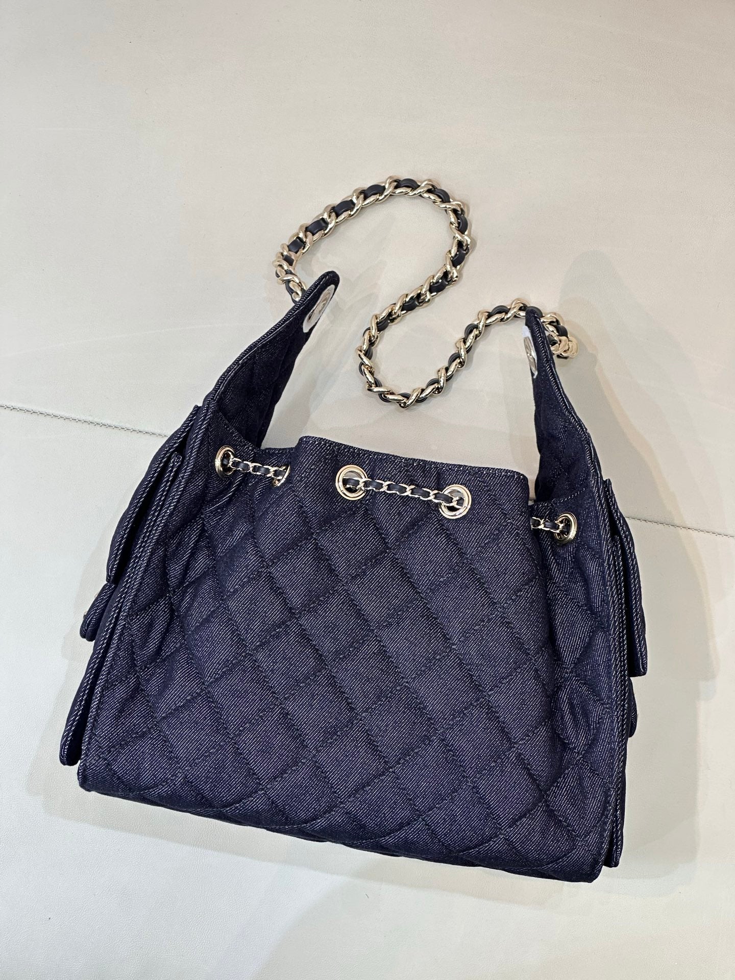 Chanel quilted dark blue shoulder bag with chain strap and front logo hardware
