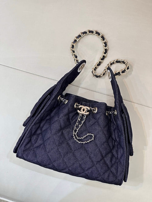 Chanel quilted dark blue bucket bag with chain strap and gold logo hardware