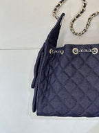 Chanel quilted dark blue bag front with grommet details and chain strap