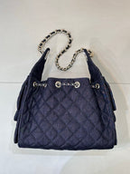 Chanel quilted dark blue bucket bag with chain top handle and gold ring charm