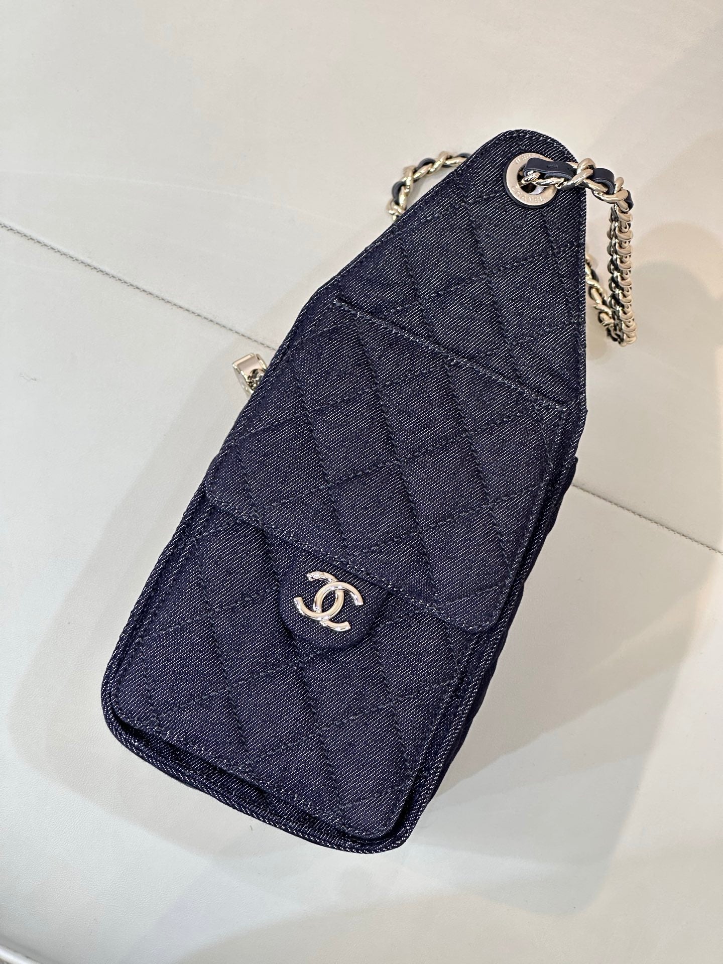 Chanel quilted dark blue clutch with chain strap and circular logo detail