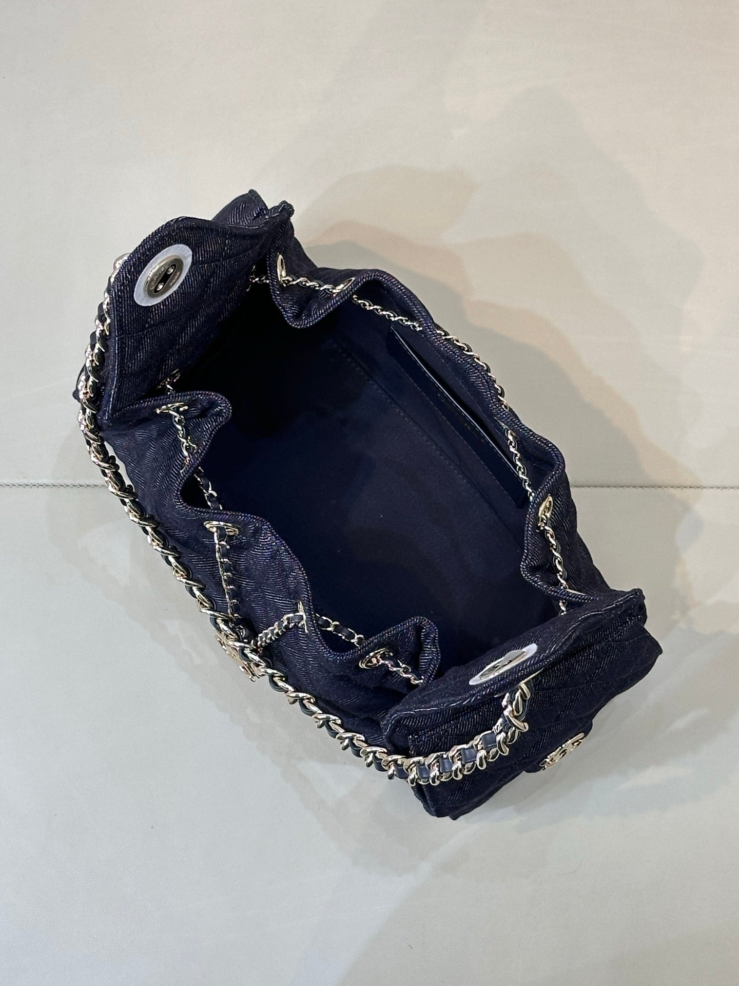 Chanel quilted dark blue bag interior with chain trim and snap closure