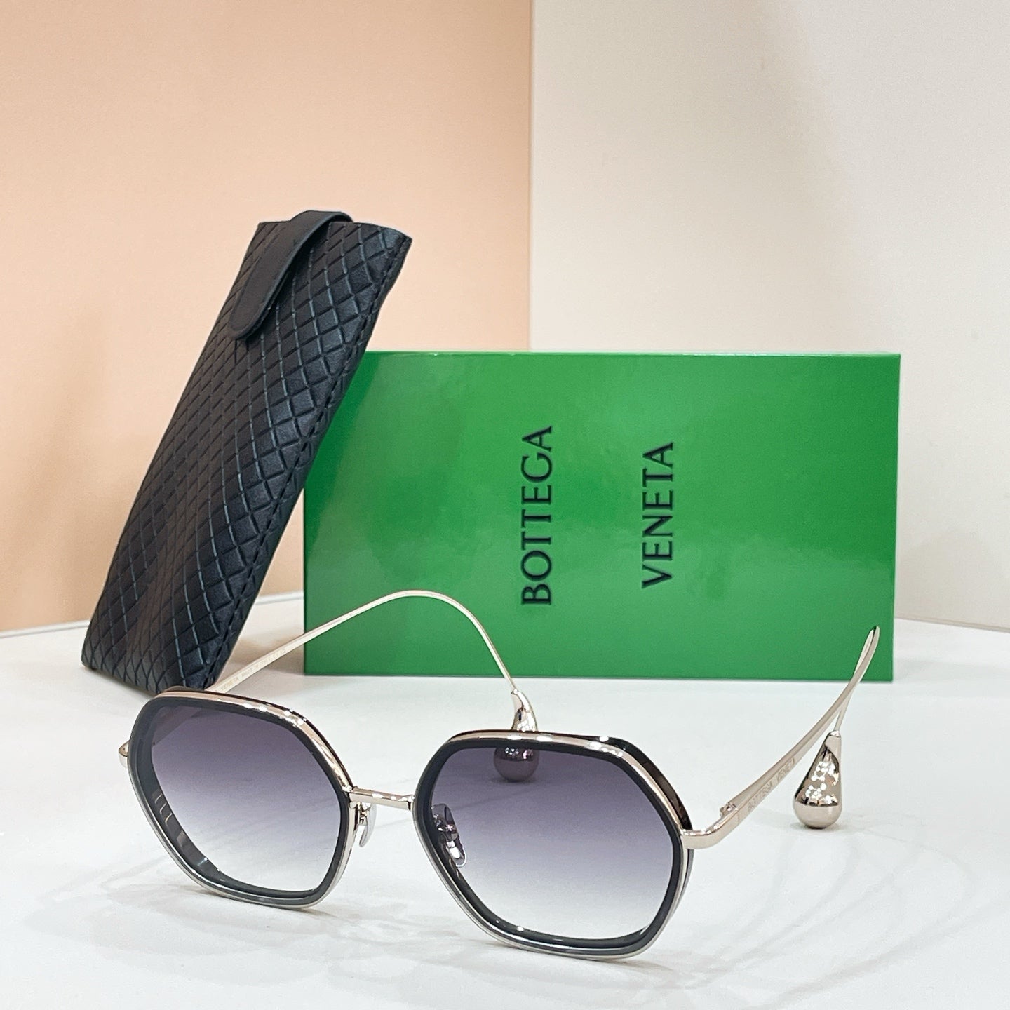 Bottega Veneta sunglasses with dark-tinted lenses and silver-tone frame