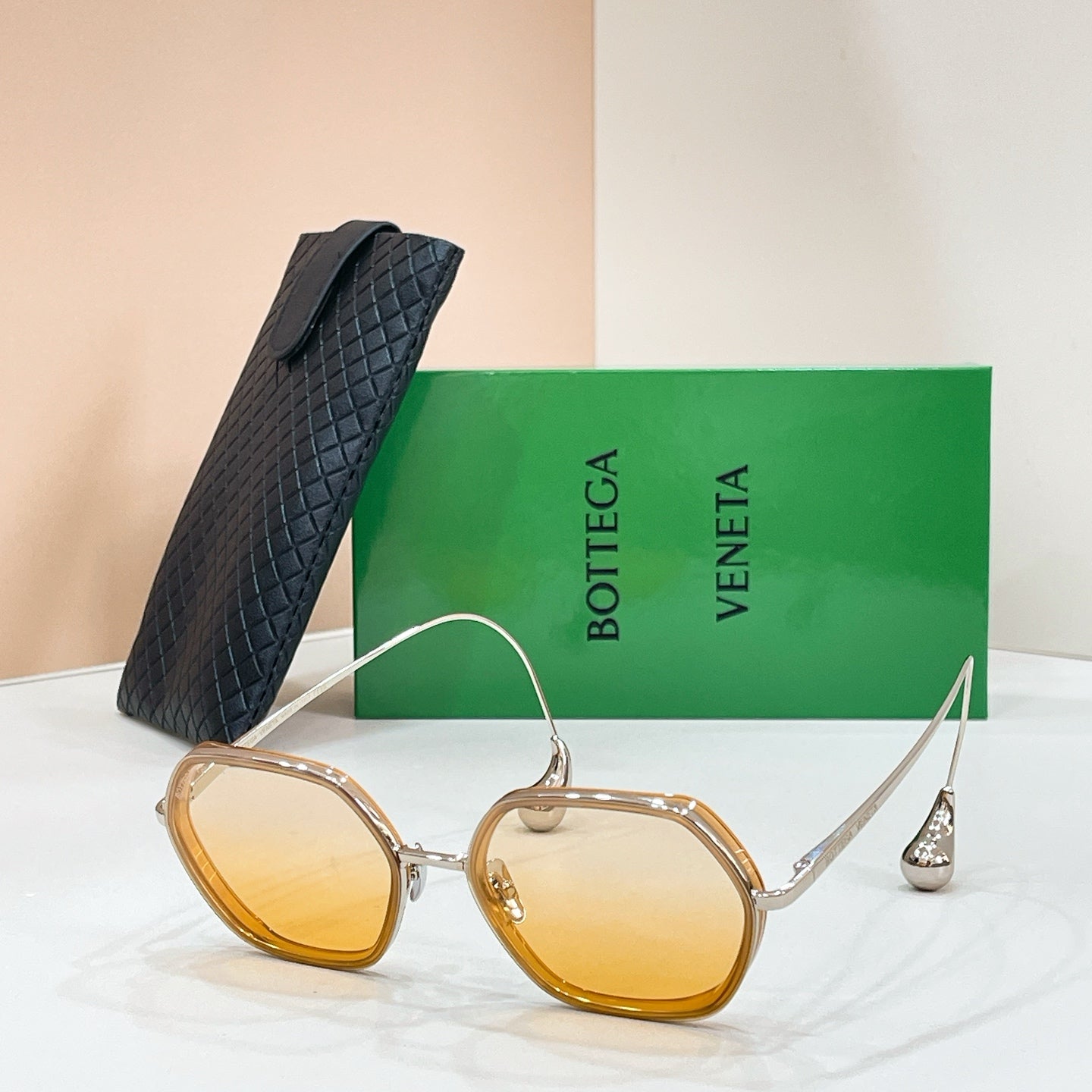 Bottega Veneta sunglasses with gold-tone frame and amber-tinted lenses