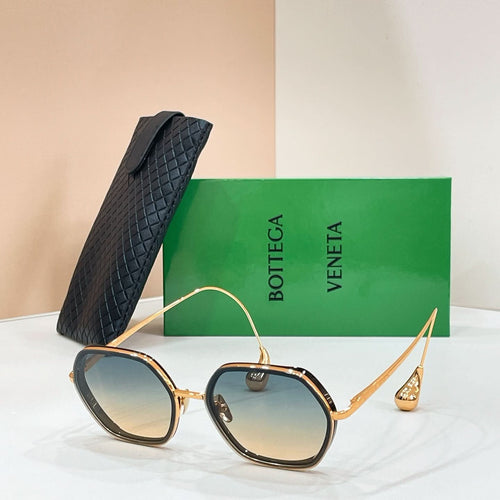 Bottega Veneta sunglasses with gold-tone frame and blue-tinted lenses