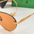 Bottega Veneta sunglasses close-up of gold temple with “BOTTEGA VENETA” text
