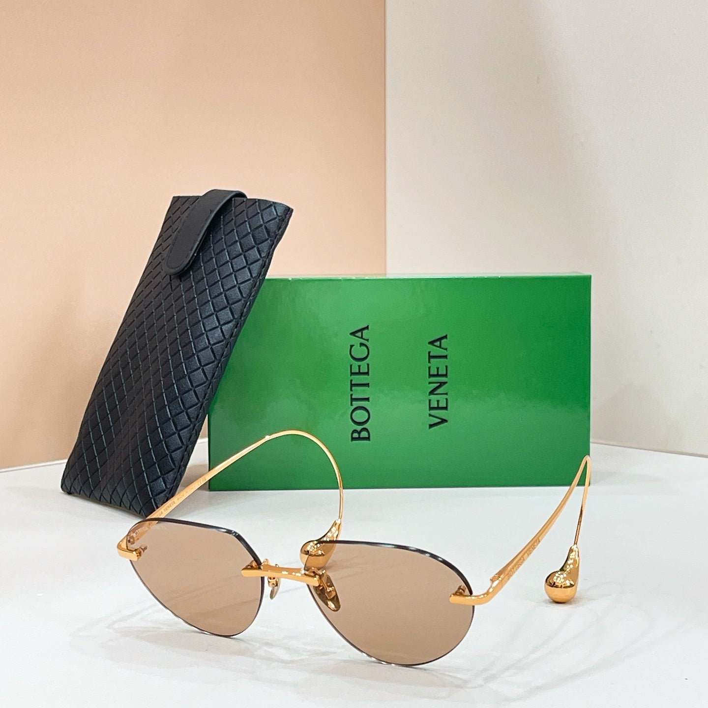 Bottega Veneta aviator sunglasses with gold frame and light amber lenses