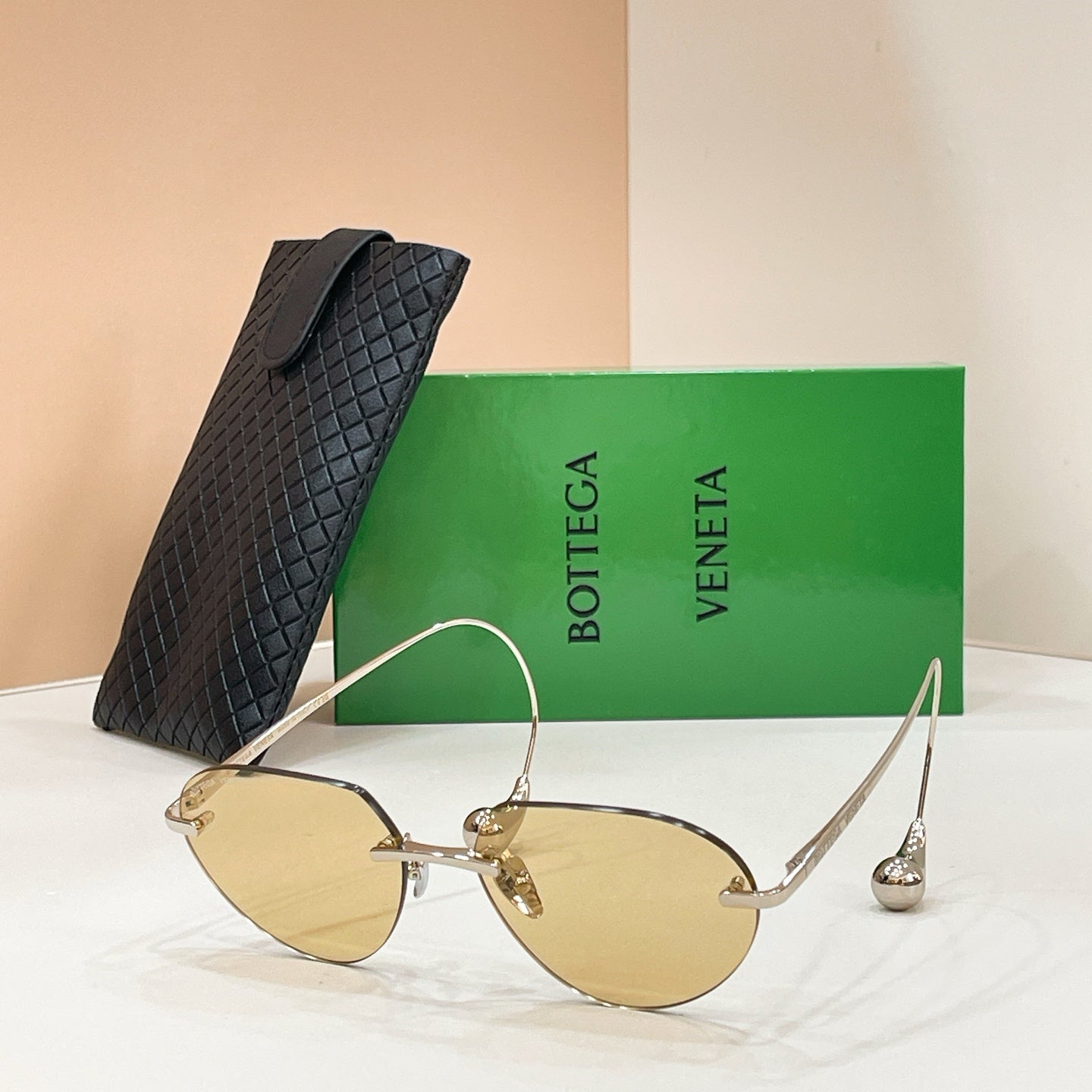 Bottega Veneta aviator sunglasses with gold frame and amber lenses