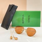 Bottega Veneta aviator sunglasses with gold frame and amber lenses