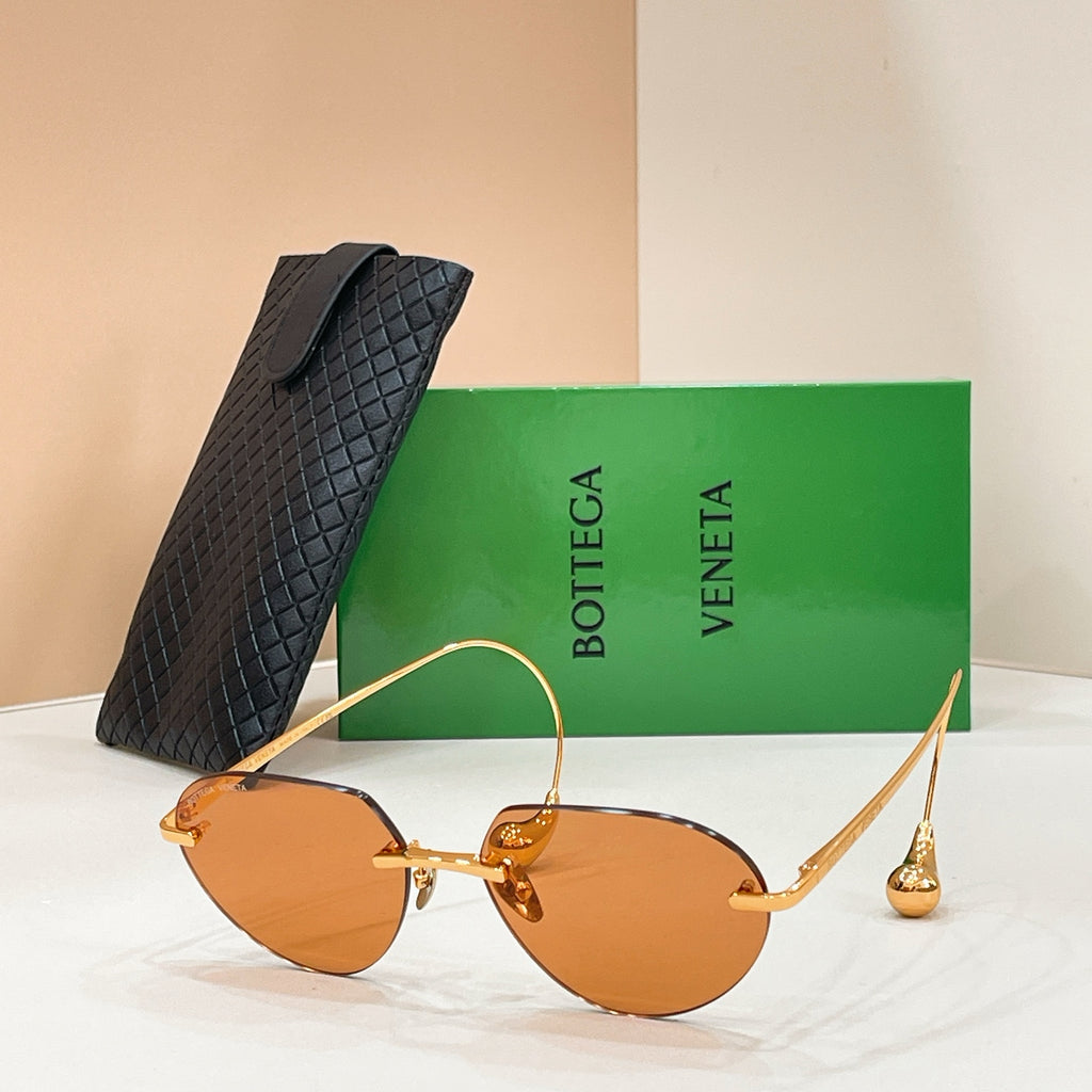 Bottega Veneta aviator sunglasses with gold frame and orange-amber lenses
