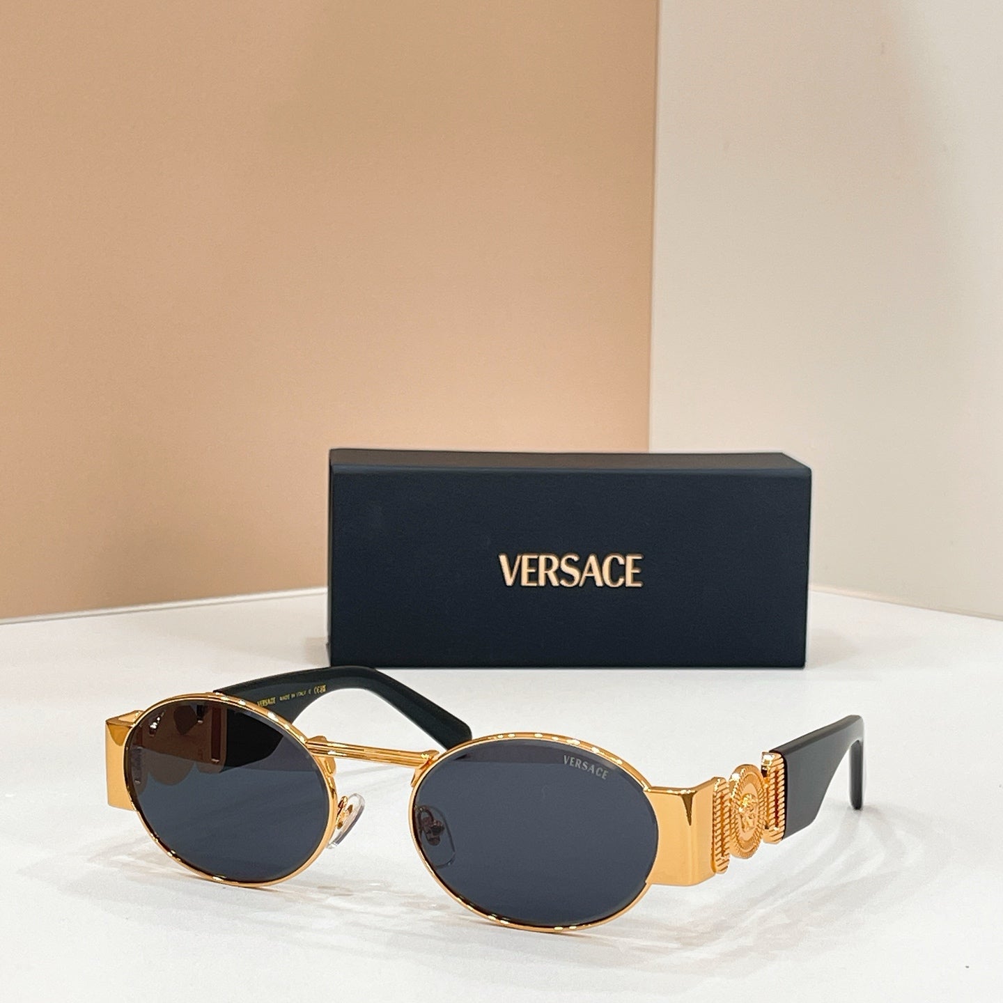Versace sunglasses with round dark lenses and gold-tone frame