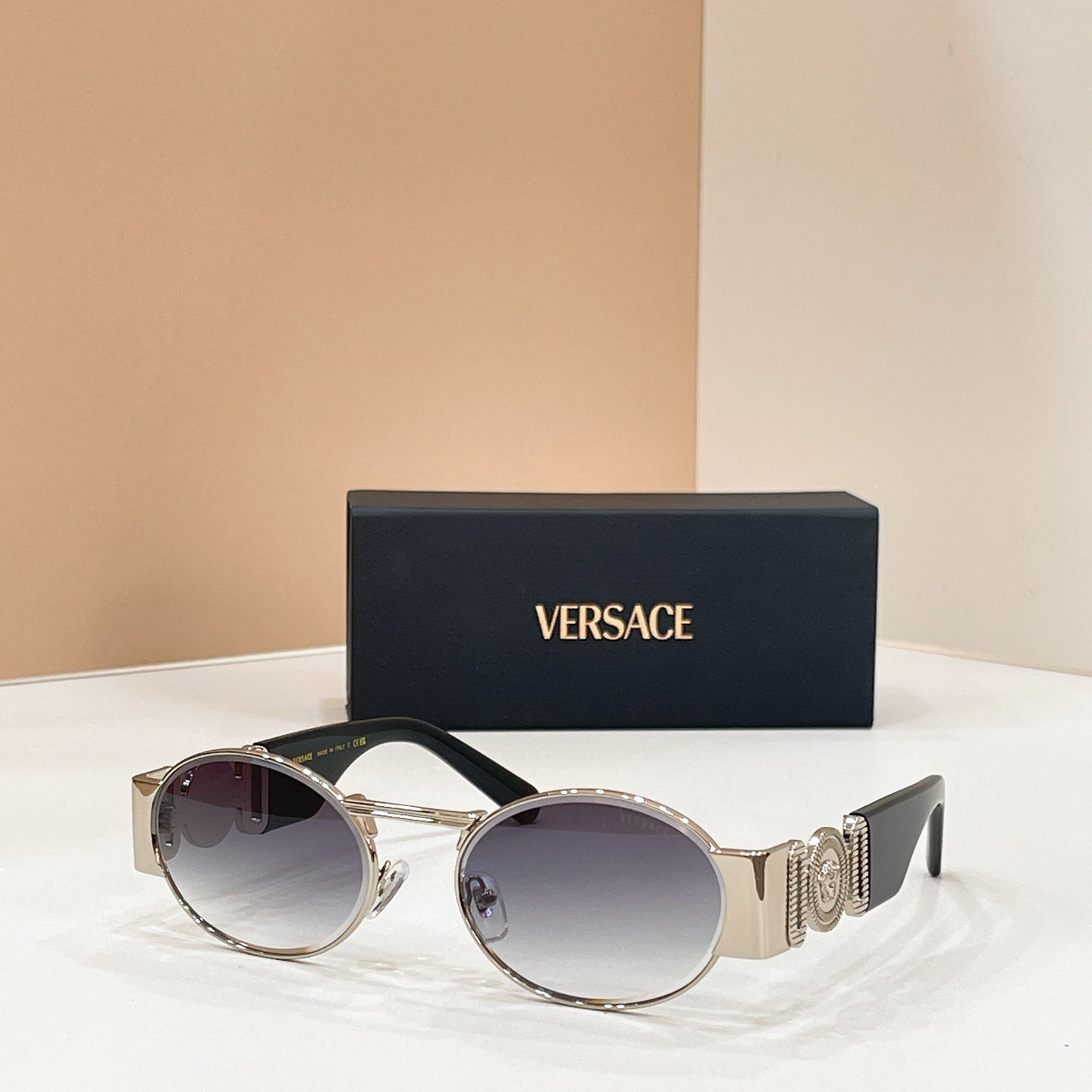 Versace sunglasses with round dark lenses and silver-tone frame