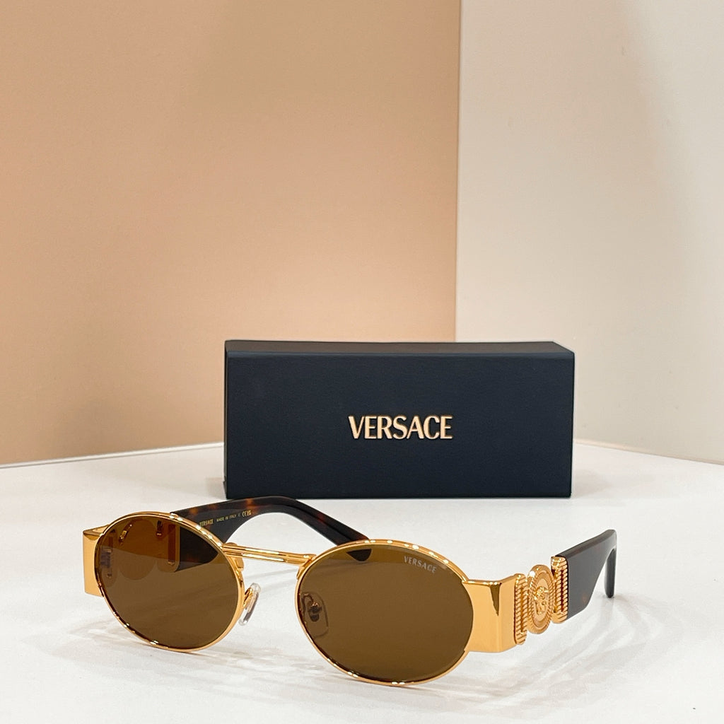 Versace sunglasses with round amber lenses and gold-tone frame, black tips