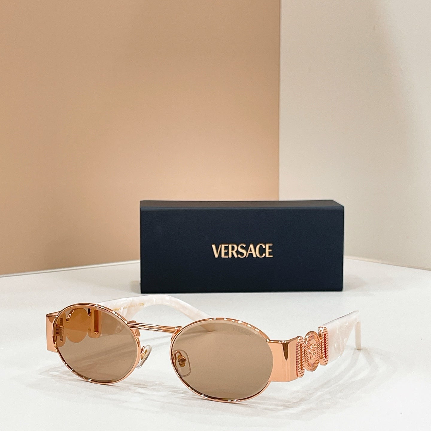 Versace sunglasses with round amber lenses and gold-tone frames
