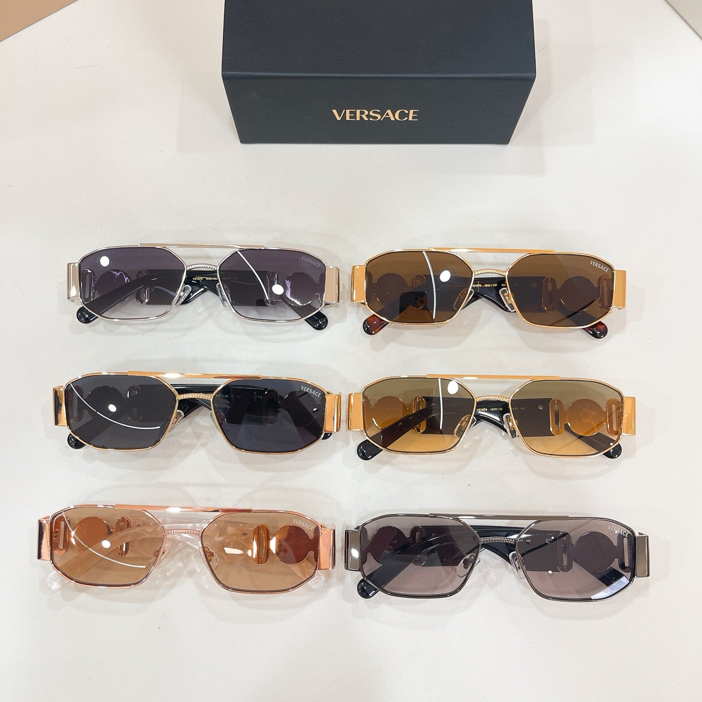 Versace sunglasses set of four pairs on display, mixed frames with dark lenses
