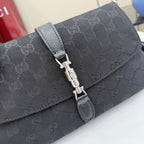 Gucci flap bag in dark gray-black jacquard with metal turn-lock clasp and textured strap