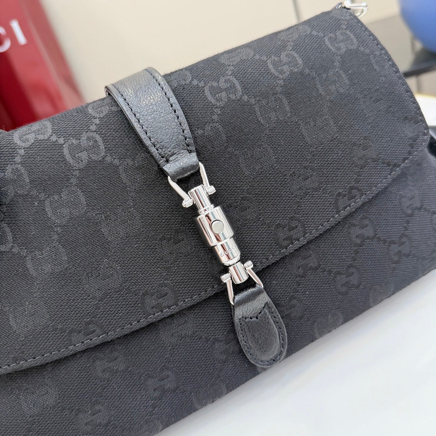 Gucci flap bag in dark gray-black jacquard with metal turn-lock clasp and textured strap