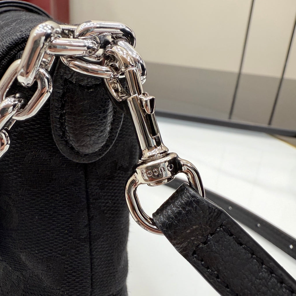 Gucci bag with black leather strap and silver-tone chain hardware clasp detail