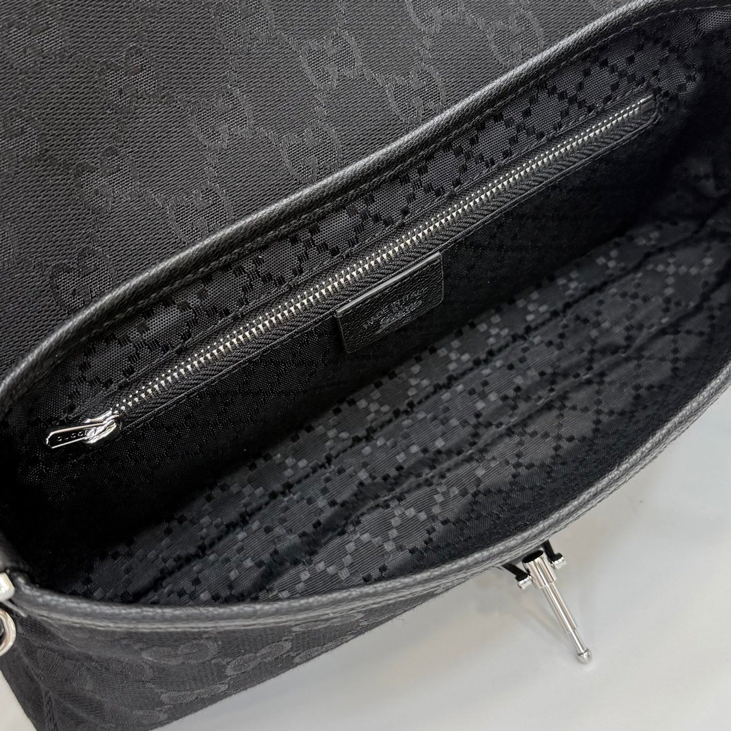 Gucci interior of black jacquard bag with zipper pocket and fabric lining